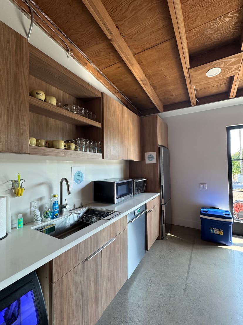 Modern kitchen with wooden cabinets, stainless steel appliances, and a stainless sink.